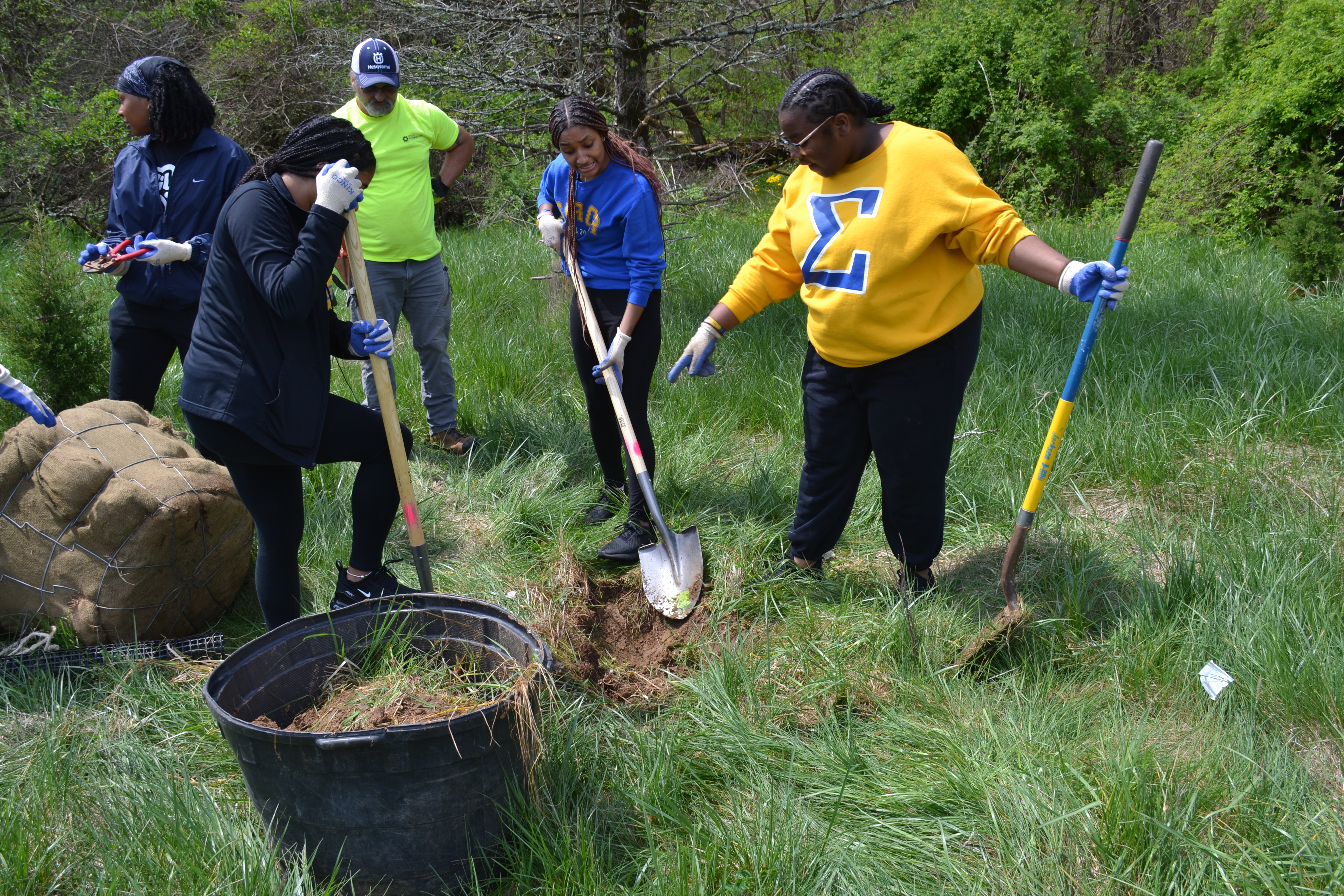 Volunteers plant one of 40, 2" caliper native trees at RCA Community Park April 29.
