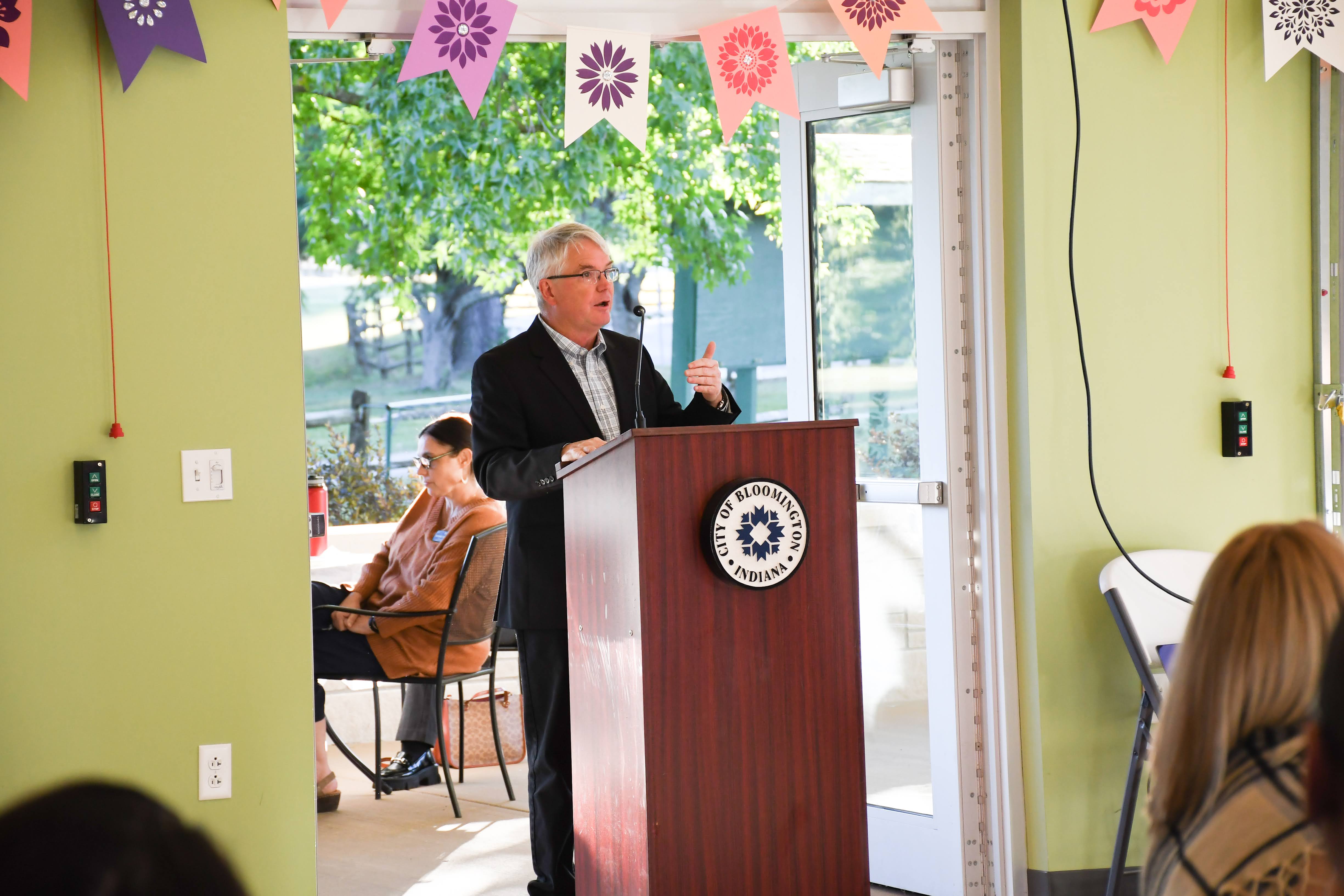 Mayor Hamilton speaking at a podium to board and commission members during event.