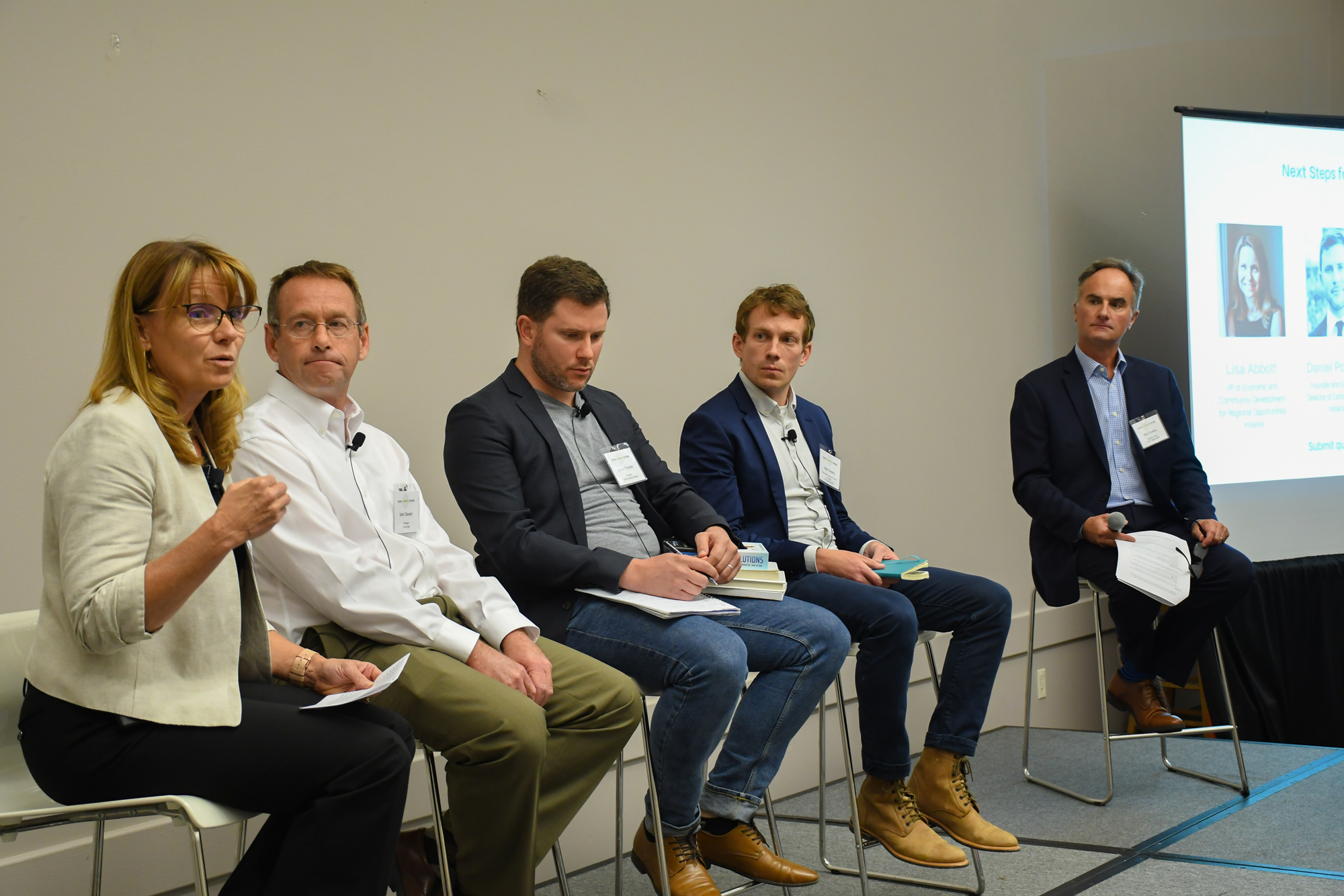 Panelists Lisa Abbott, Daniel Poynter, Mark Stewart, Bloomington council member Matt Flaherty, and moderator Alex Crowley discuss next steps for a tri-county partnership.