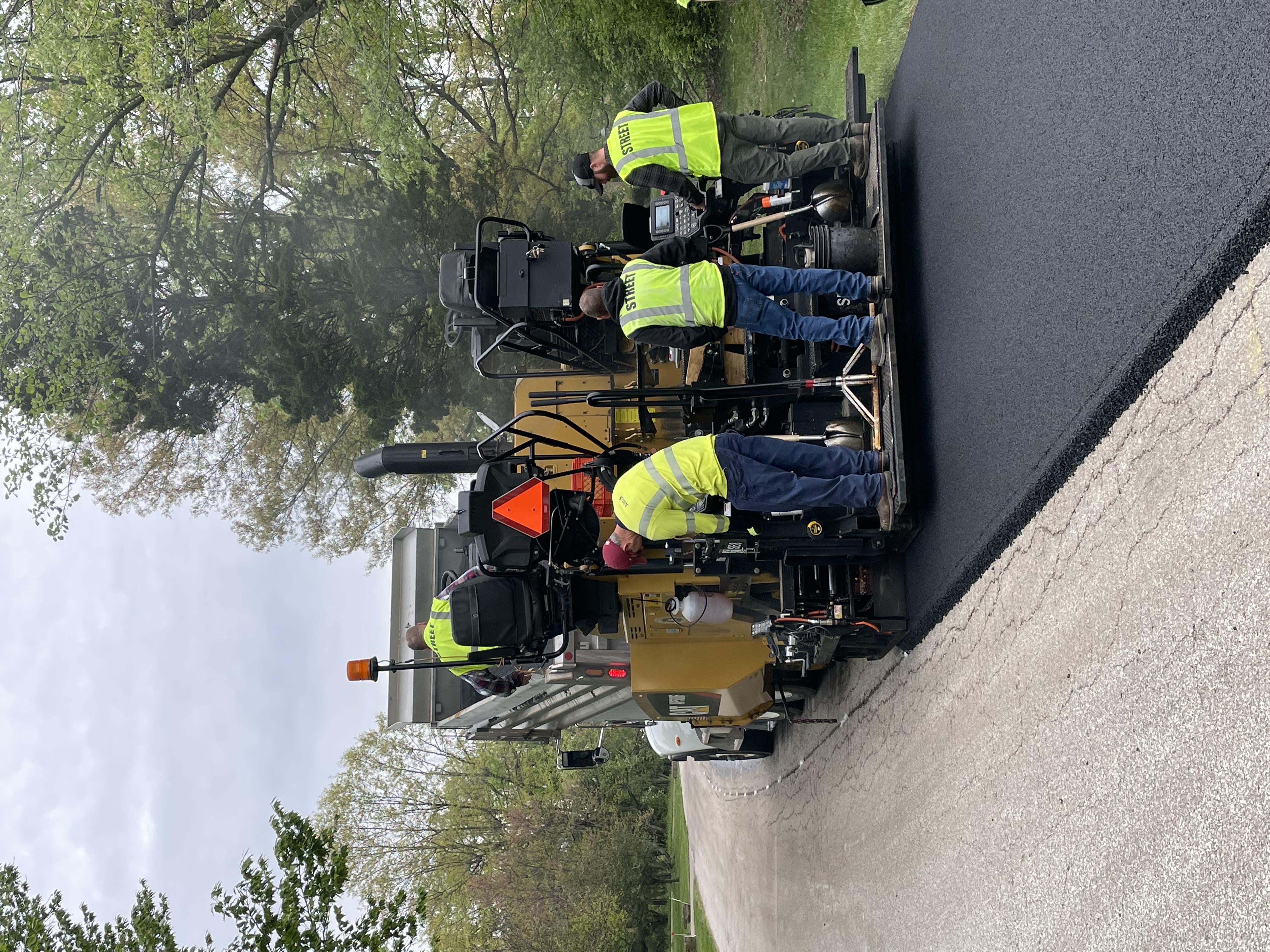 Crews on a Paver Truck installing asphalt