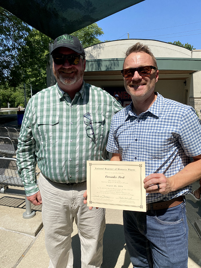 Parks and Recreation Director Tim Street, on the right, accepts a certificate from the National Register of Historic Places for Cascades Park, August 2025.