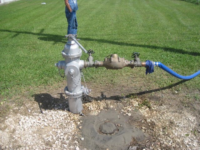 Image of a hydrant with meter and hose attached