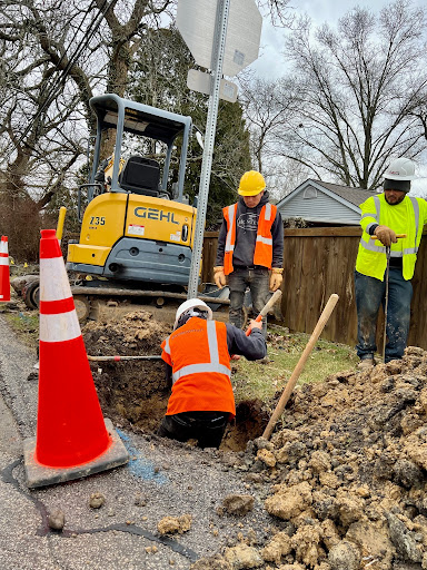 Crews digging and installing fiber conduit