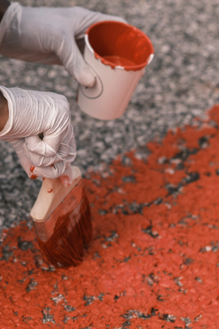 Person painting mural on street