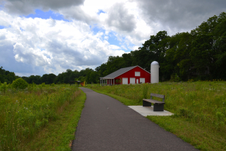 Red barn and restored native prairie at Rogers Family Park in July 2023.