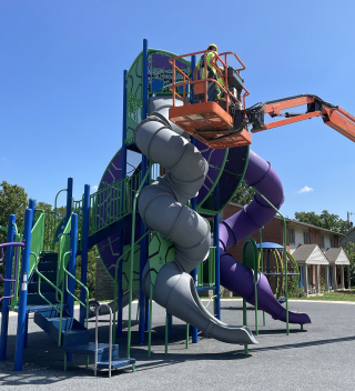 Parks staff repair the slide at Crestmont Park