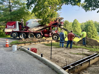 Concrete curbs being poured around the pad that upon which fitness equipment will be installed at Southeast Park.