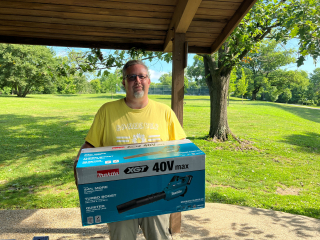 parks staff members holds new battery powered leaf blower