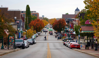 autumn scene of Kirkwood Ave looking west, cars, bikes, pedestrians