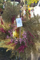 wreath of dried green, pink and red flowers