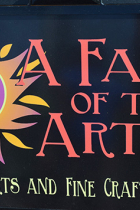 A Fair of the Arts logo on black background