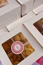 Market food and beverage artisan cookies in white boxes