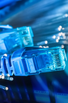 Network cables and optic fibers on bright blue background